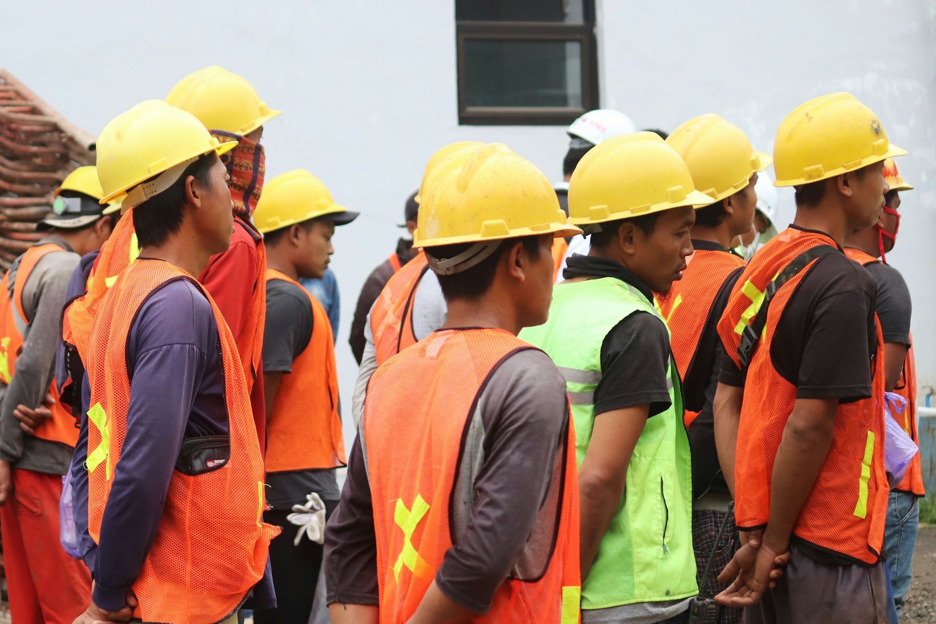 Site crew in hard hats and high-visibility vests